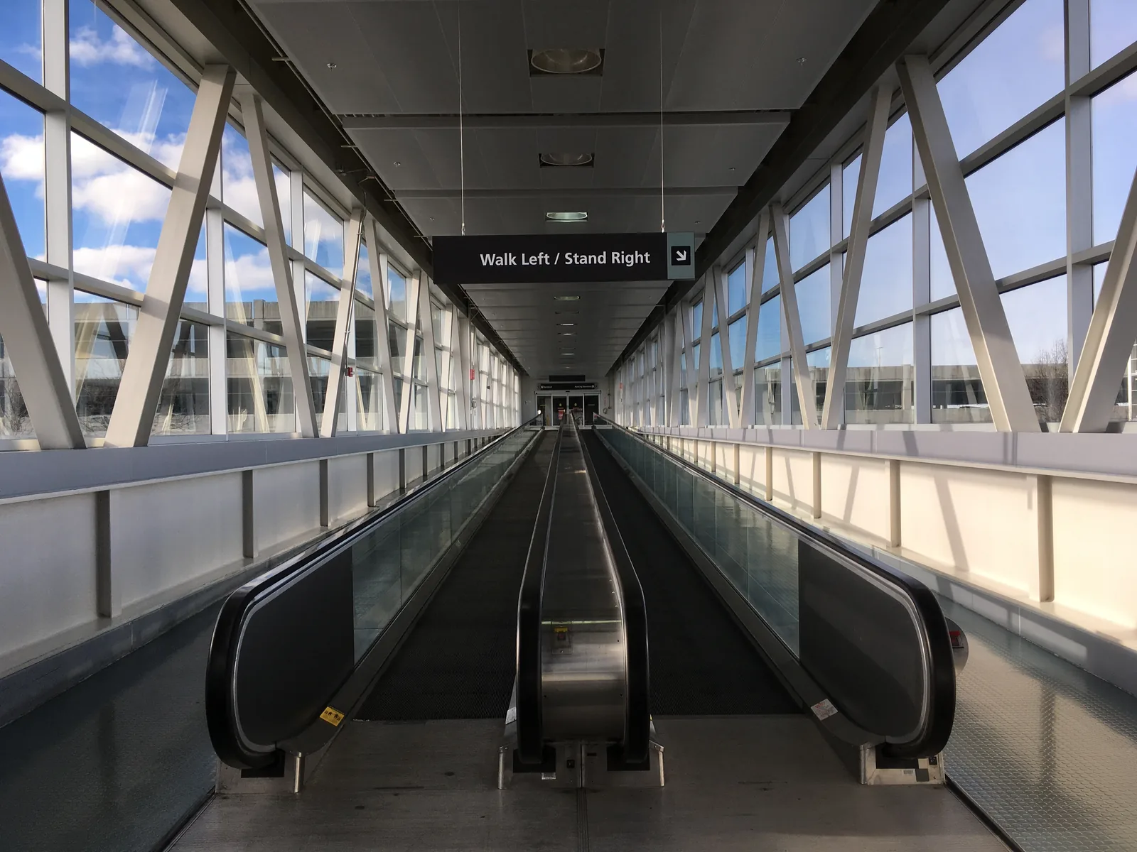 The moving walkway along a concourse at Cleveland Hopkins International Airport, under the glass roof.