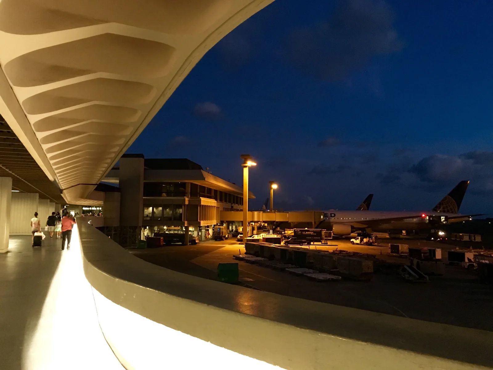 The curbside at Daniel K. Inouye International in Honolulu, at dusk.