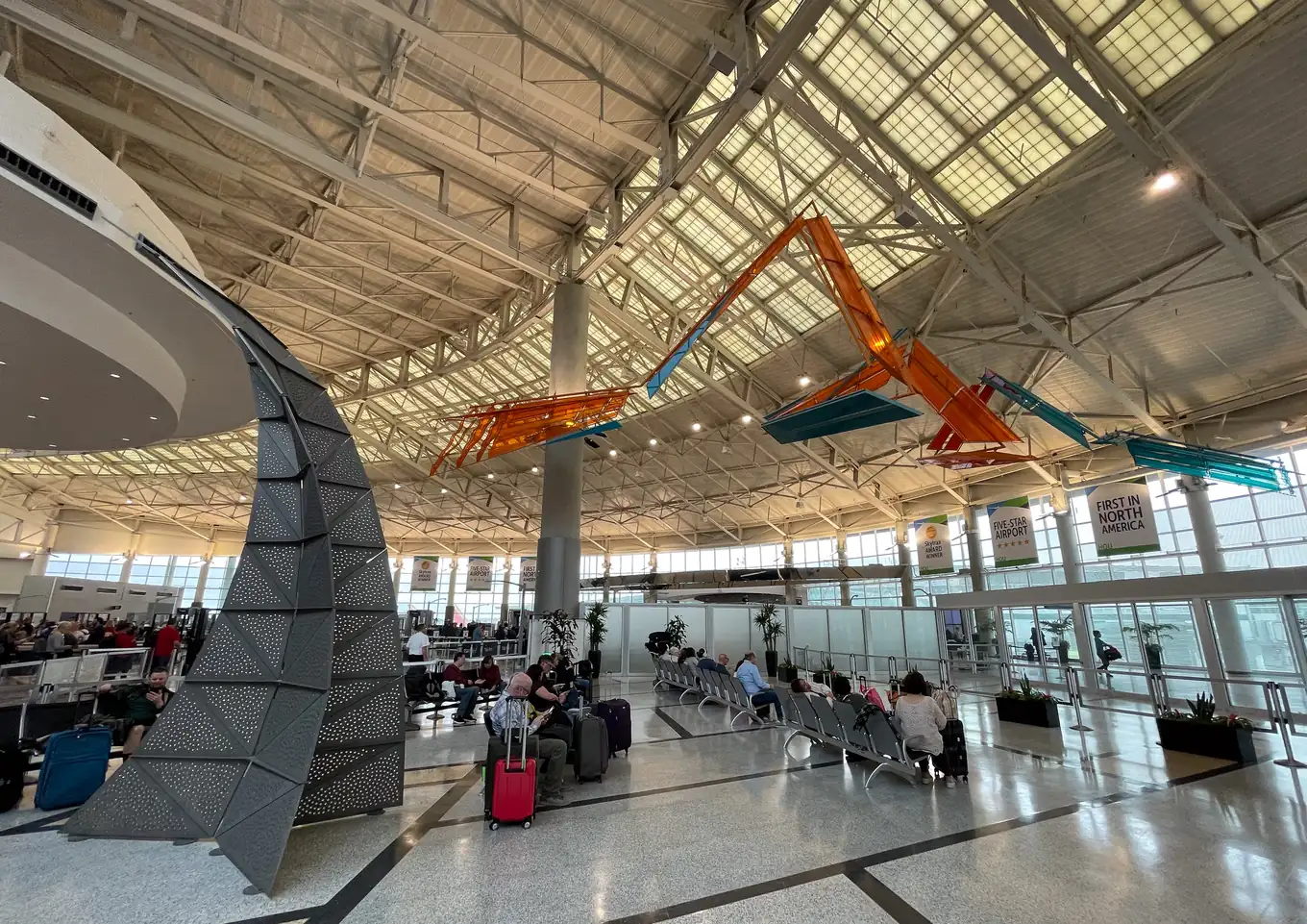 Inside the terminal at William P. Hobby Airport in Houston, with the aircraft sculptures hung under the roof.