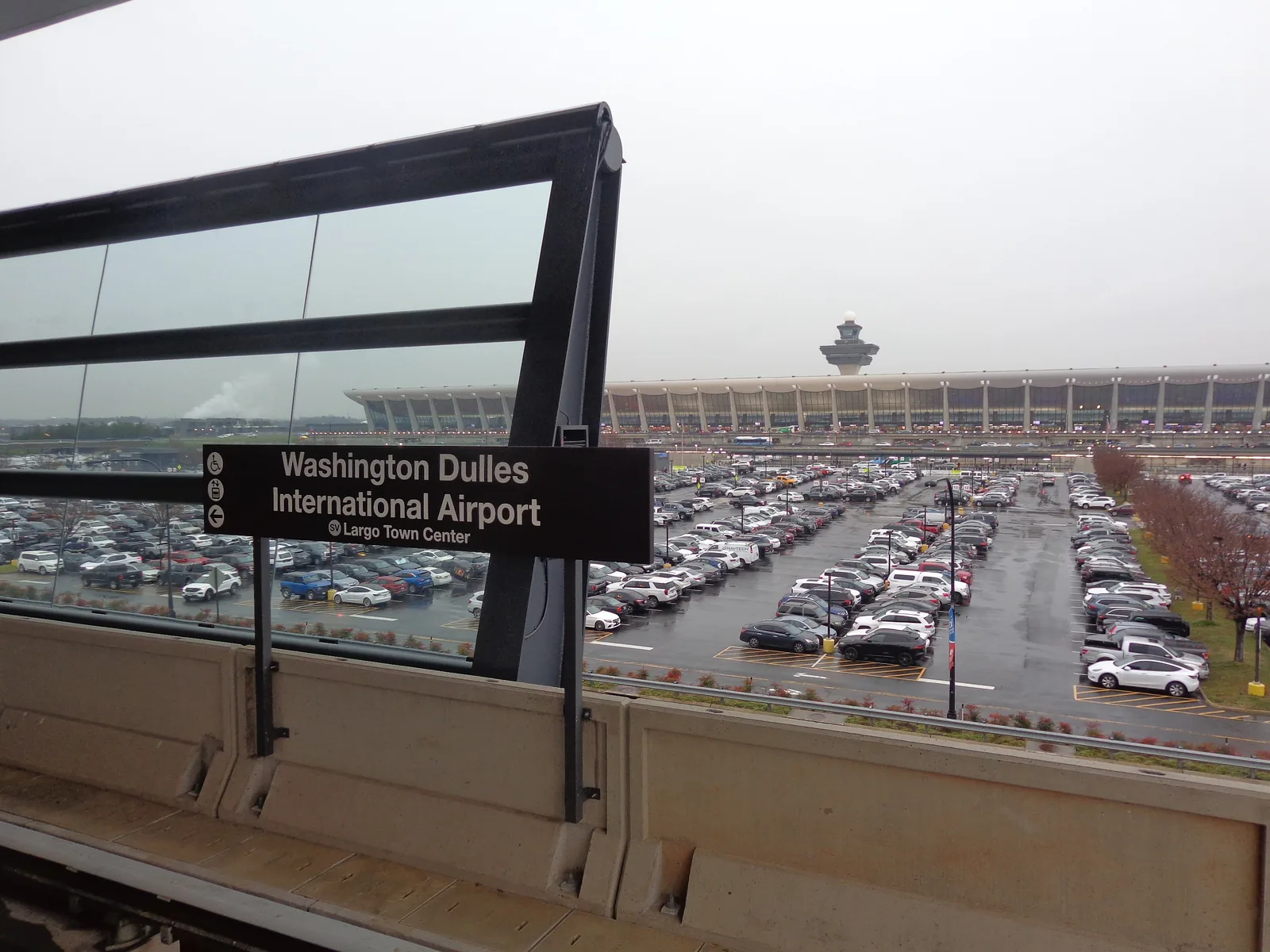 The Metro station signpost at Dulles, with the main terminal behind it.