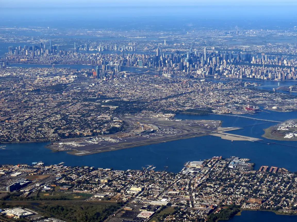 LaGuardia from the air, with the Manhattan skyline behind it.