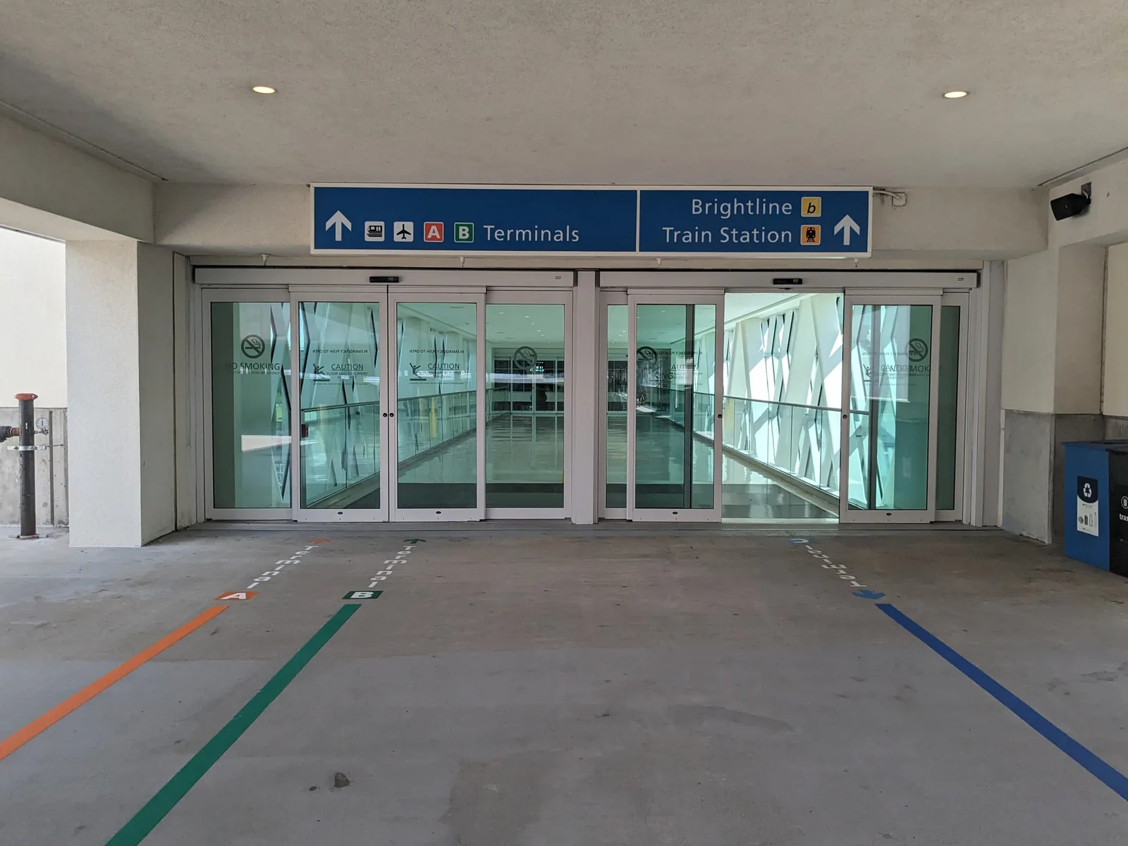 The way in from the parking garage at Orlando International, signed for the terminals and the Brightline station.