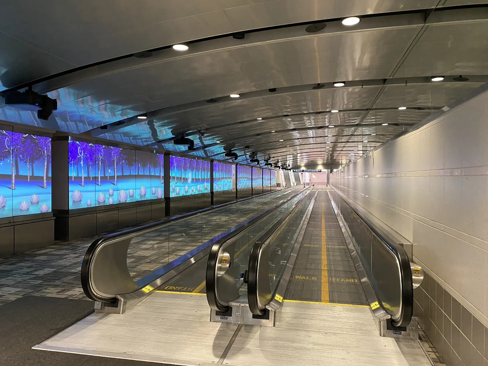 The lit connector walkway to Concourse B at Minneapolis-Saint Paul.