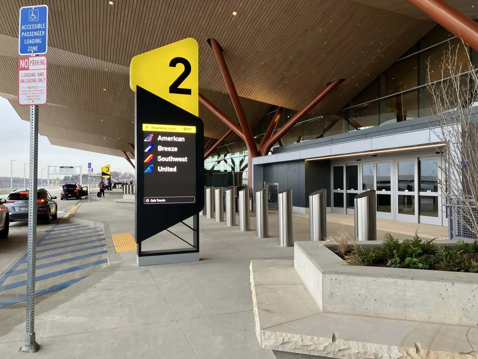 The drop-off curb at Pittsburgh International Airport's new terminal, under its timber roof.