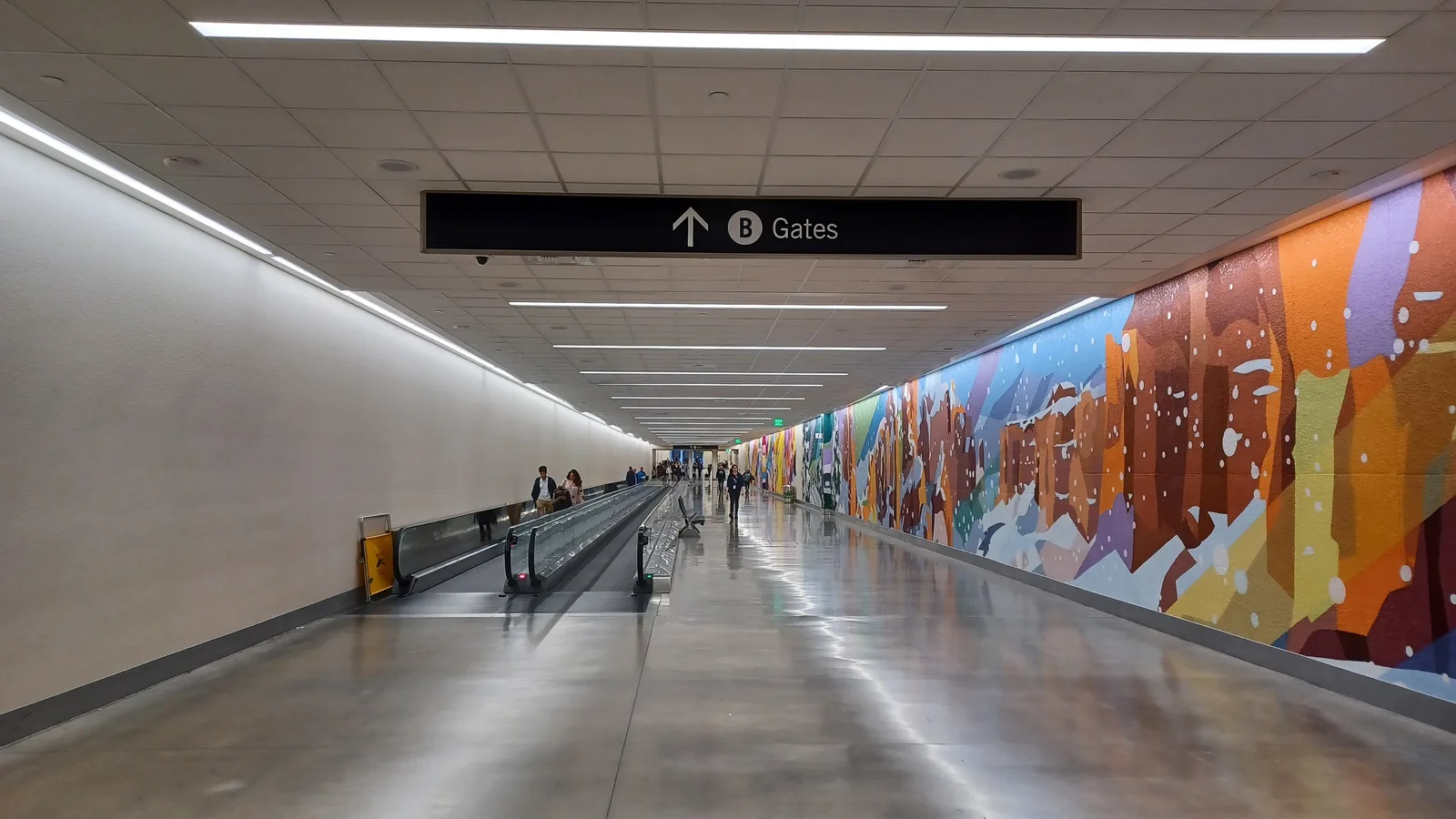 The mid-concourse tunnel at Salt Lake City International, with its canyon mural.