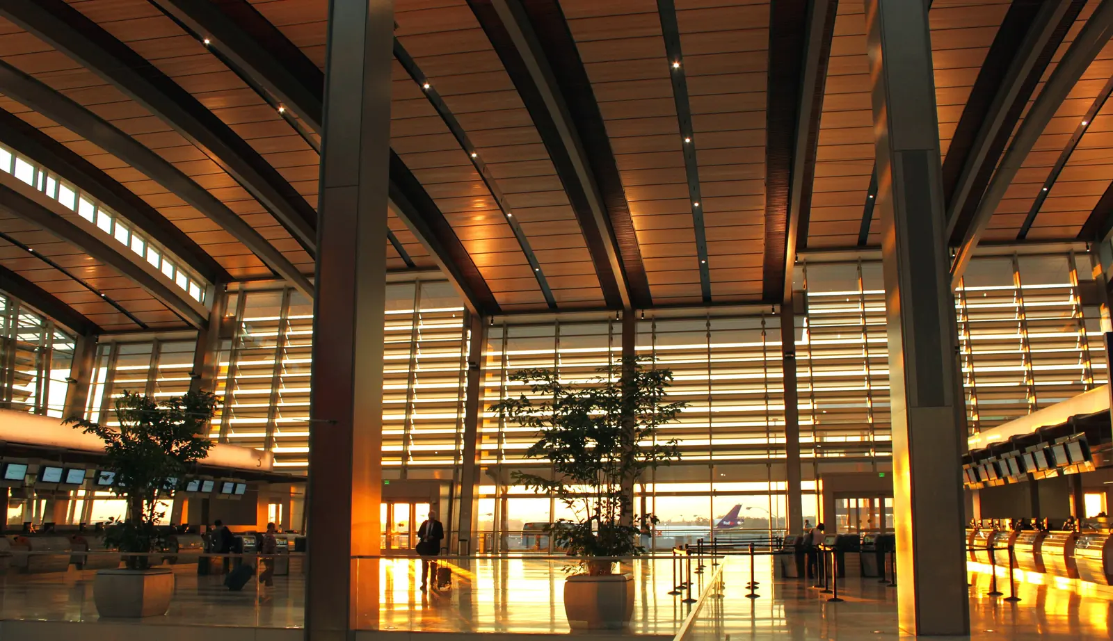 Terminal B at Sacramento International, under its timber frame at sunset.