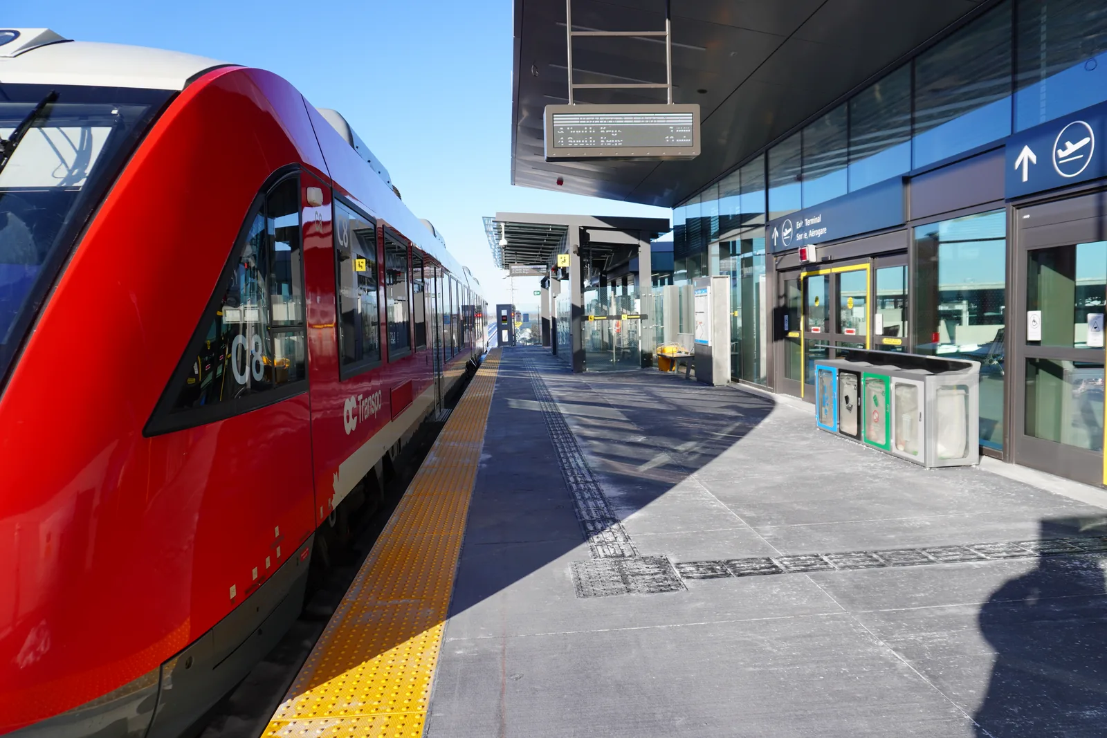 An O-Train train at the platform at Ottawa airport station.