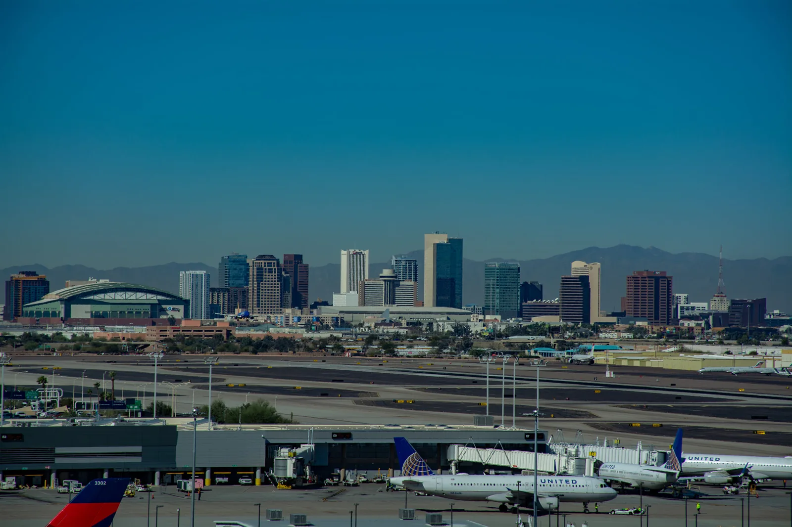 The downtown Phoenix skyline with Chase Field and the mountains behind it, seen from Sky Harbor.