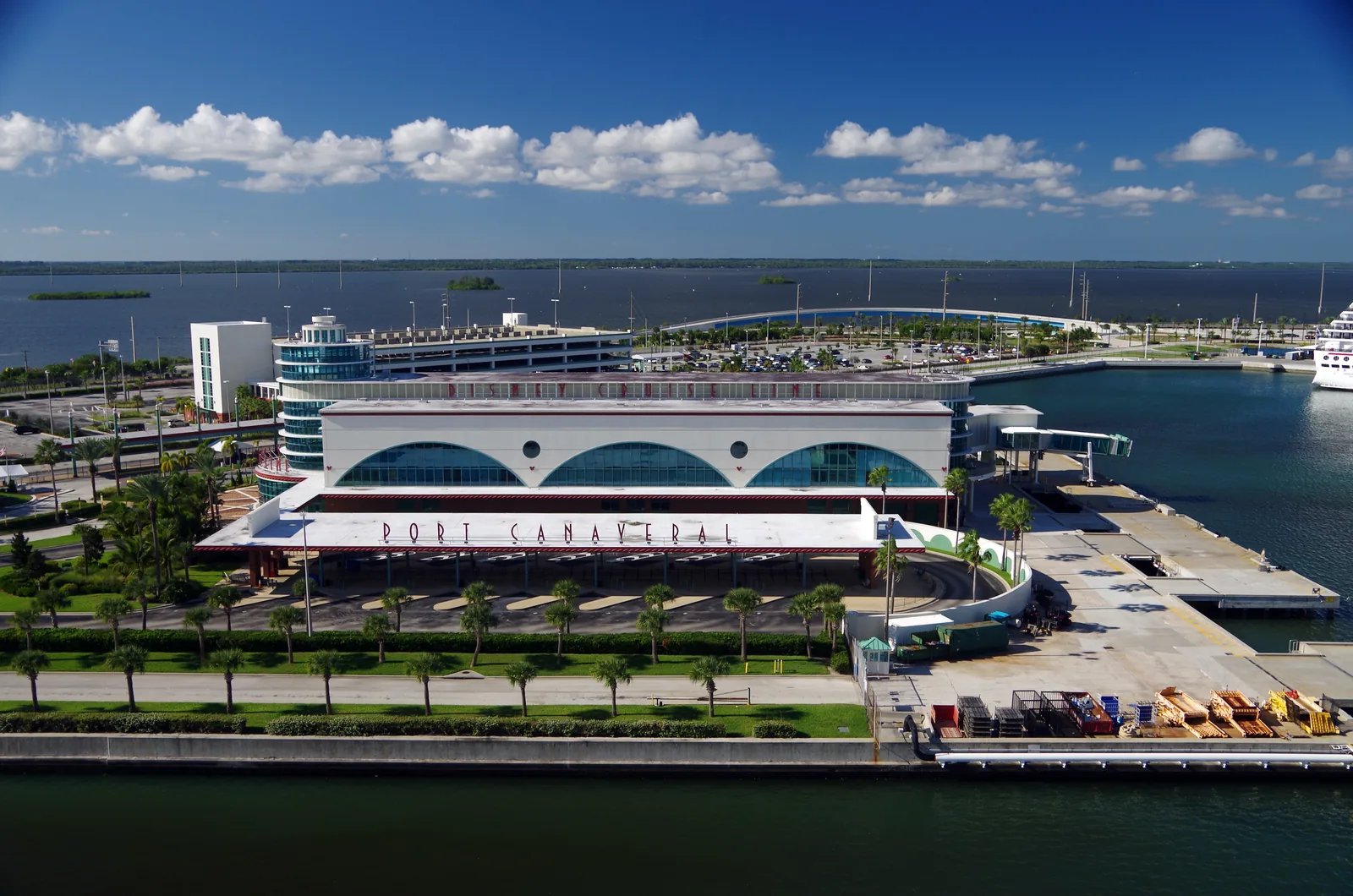 Disney Cruise Line's terminal at Port Canaveral, seen from above, with the parking garage behind it.