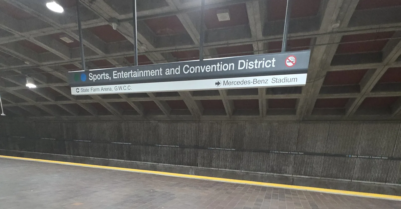 The platform sign at SEC District station on MARTA, pointing the way to Mercedes-Benz Stadium.