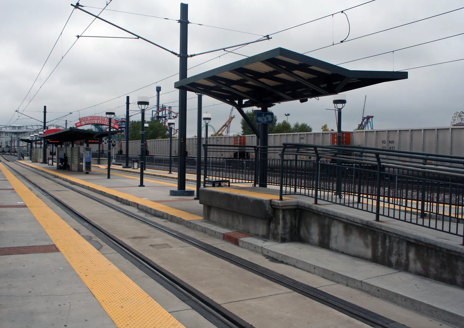 The RTD light rail platform at Ball Arena–Elitch Gardens station, beside the arena lots.