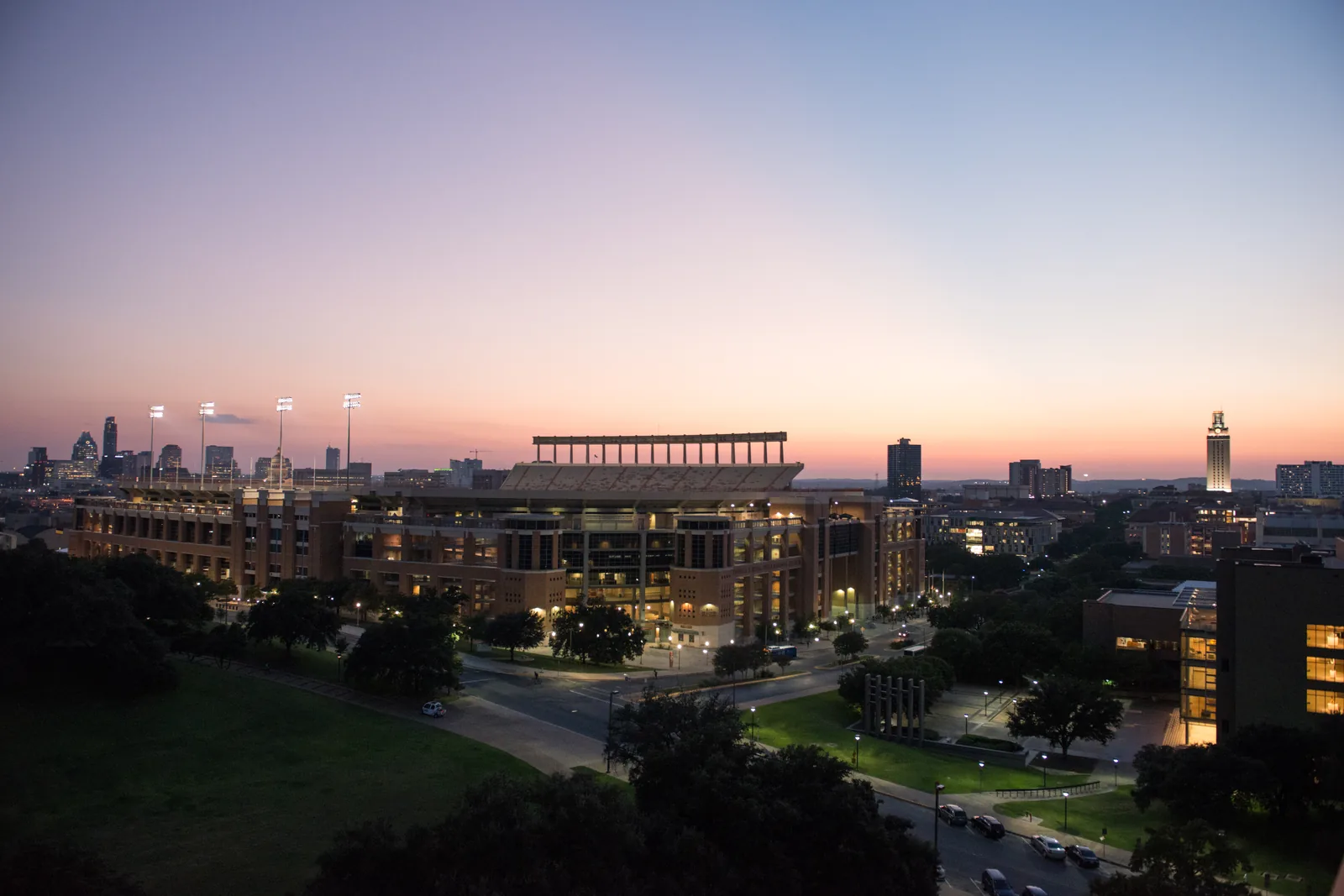 DKR-Texas Memorial Stadium at dusk, with downtown Austin behind.