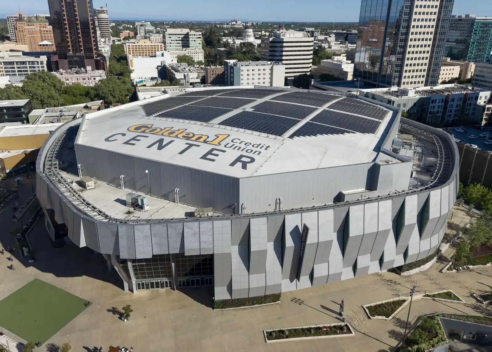 Golden 1 Center from above in downtown Sacramento, with its name on the roof.