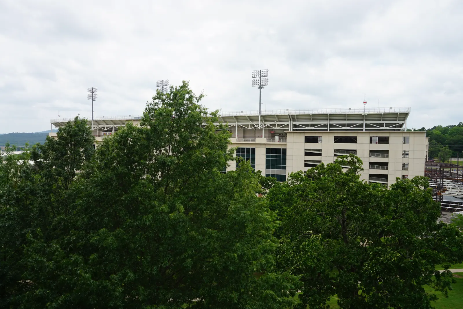 Donald W. Reynolds Razorback Stadium above the trees on the University of Arkansas campus in Fayetteville.