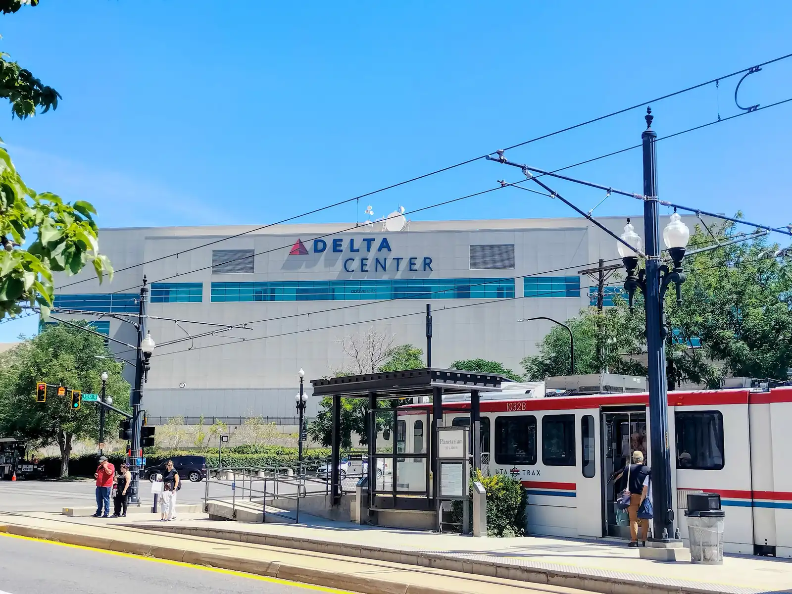 Delta Center in Salt Lake City, with a TRAX train in front.