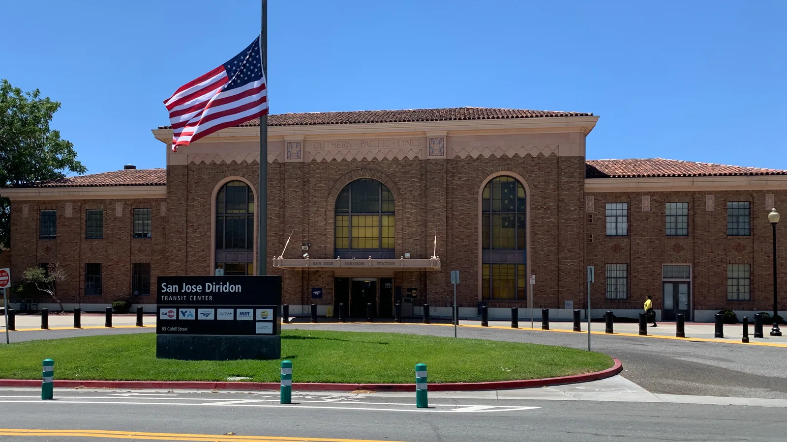 The brick front of San Jose Diridon station, with the station name on a sign beside the entrance.