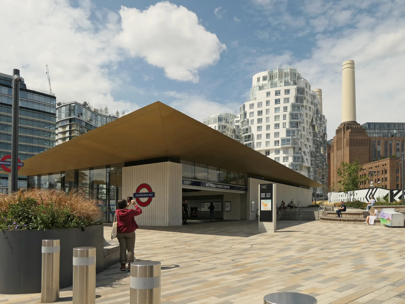 The Battersea Power Station Underground station entrance, with one of the power station&rsquo;s chimneys behind it