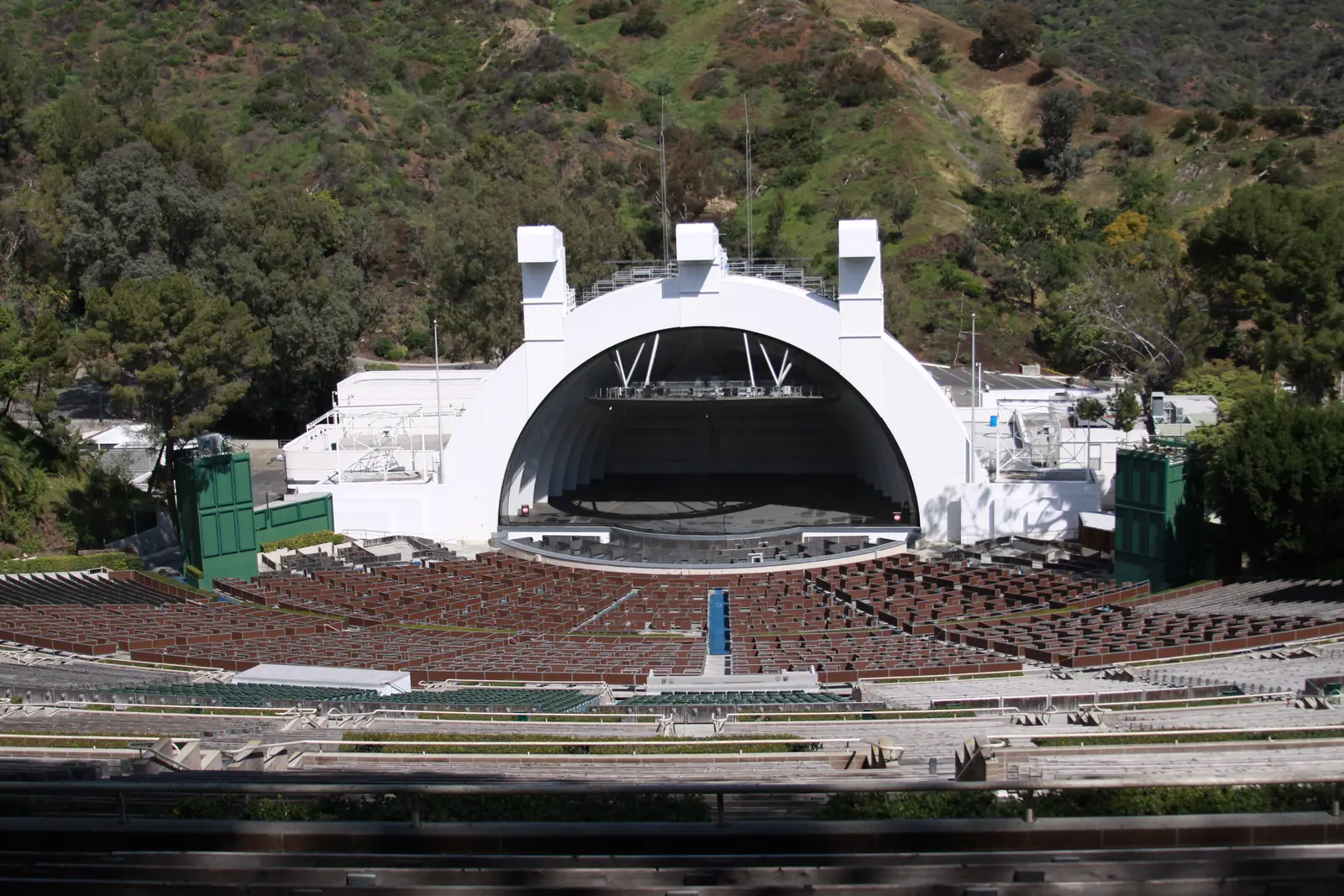 The Hollywood Bowl from the top benches, the seating running down to the white shell with the hills behind it.